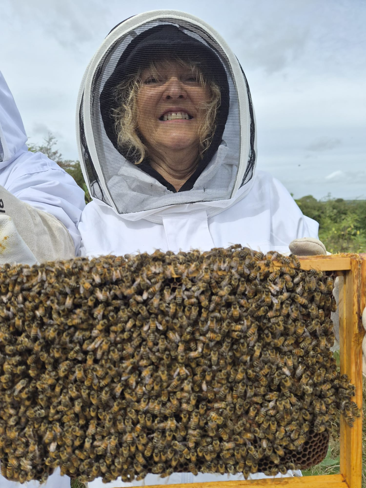 A participant trying a hands-on beekeeping activity