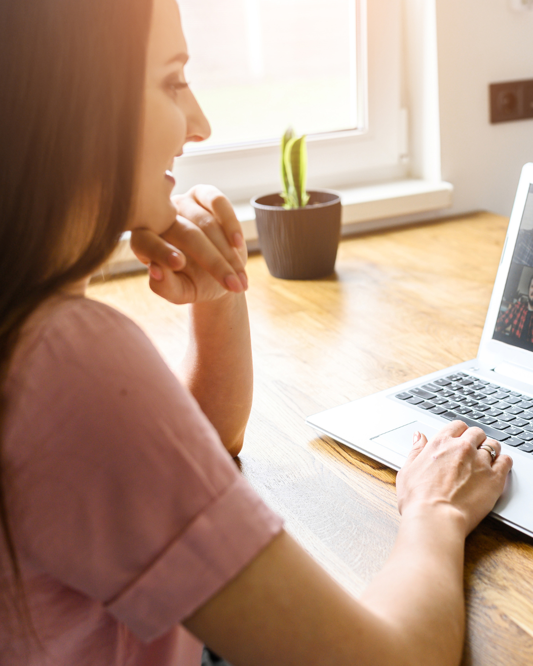 Woman taking part in an online programme from home