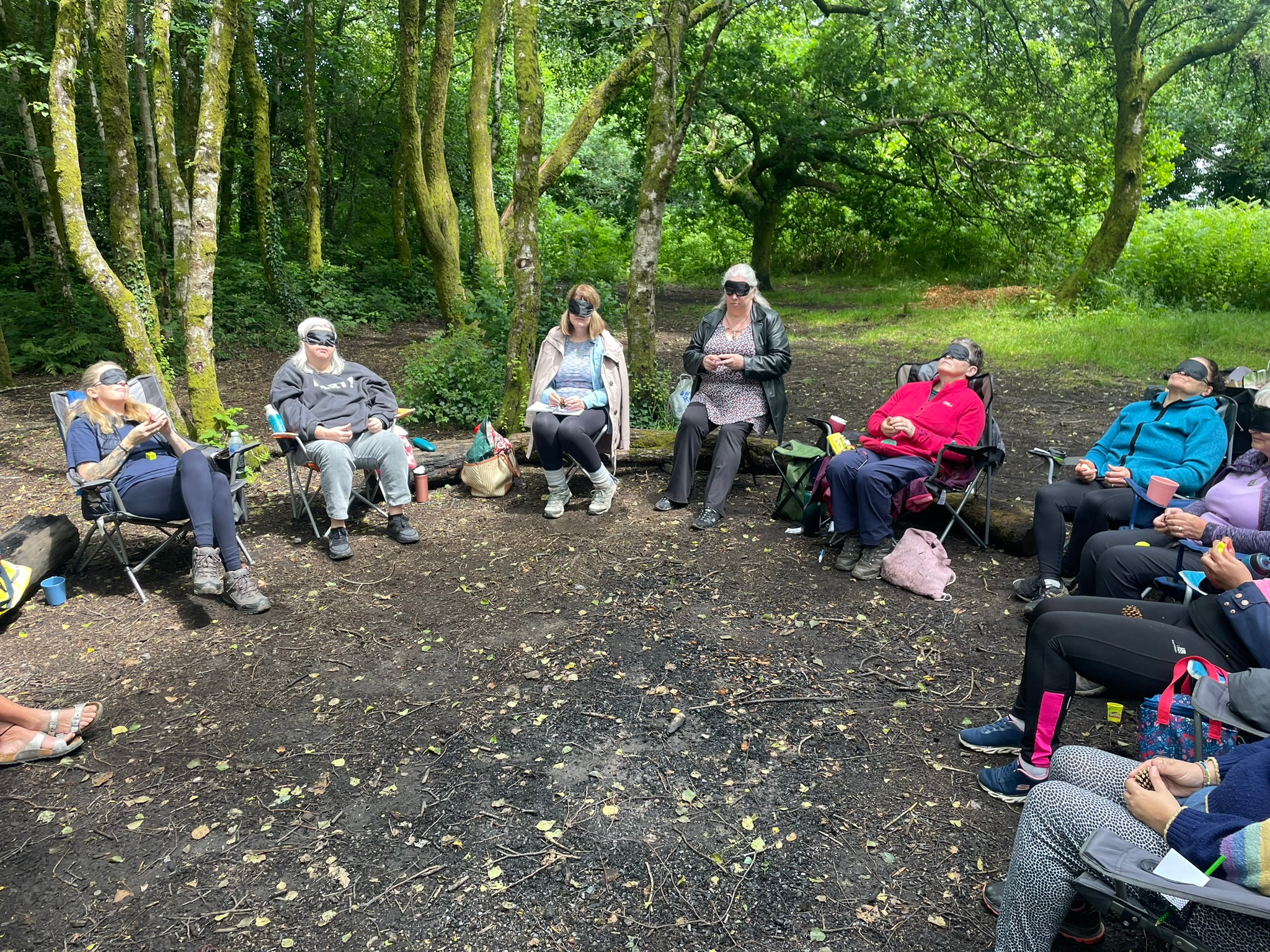 Community members sharing a quiet moment together in the woodland