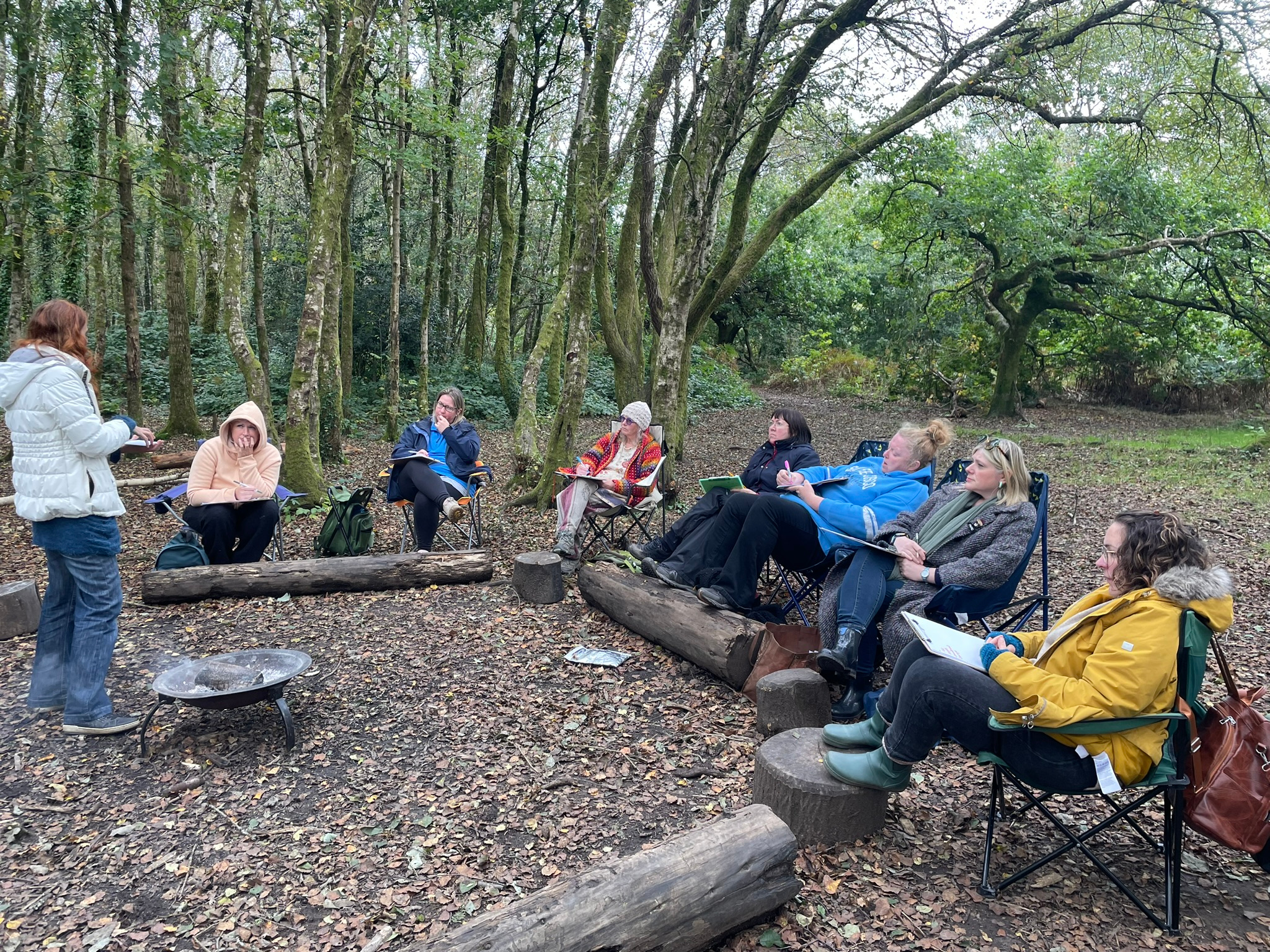 A Head Outdoors learning circle gathered among the trees