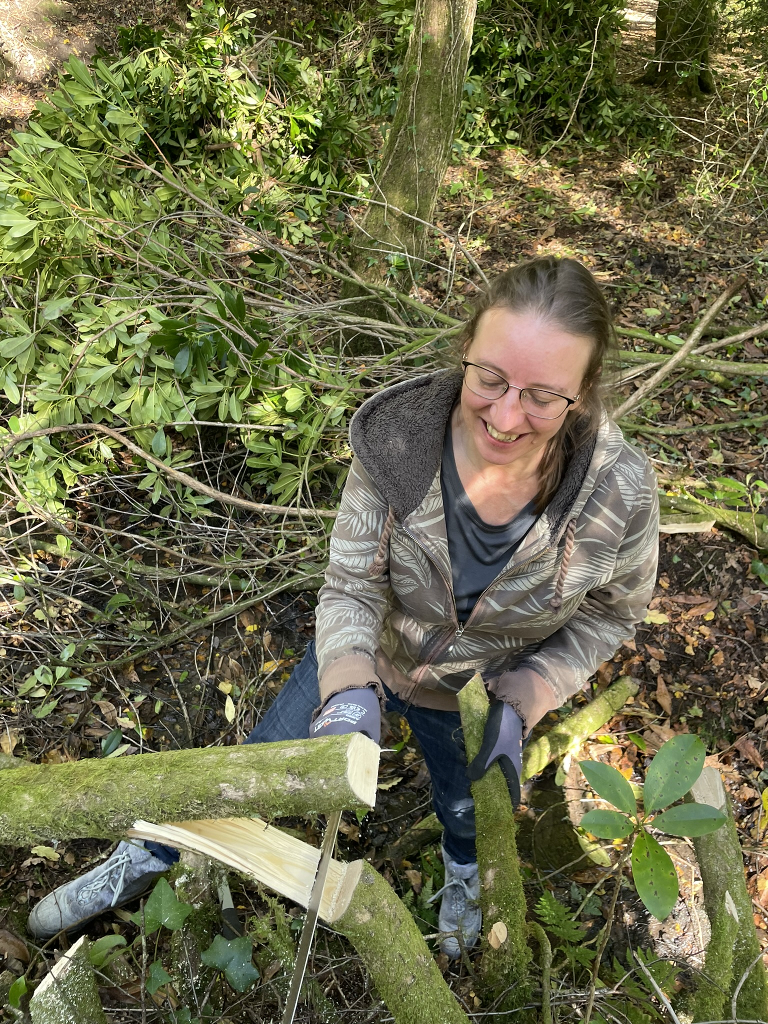 Nature Nurture participant carrying out practical woodland conservation work