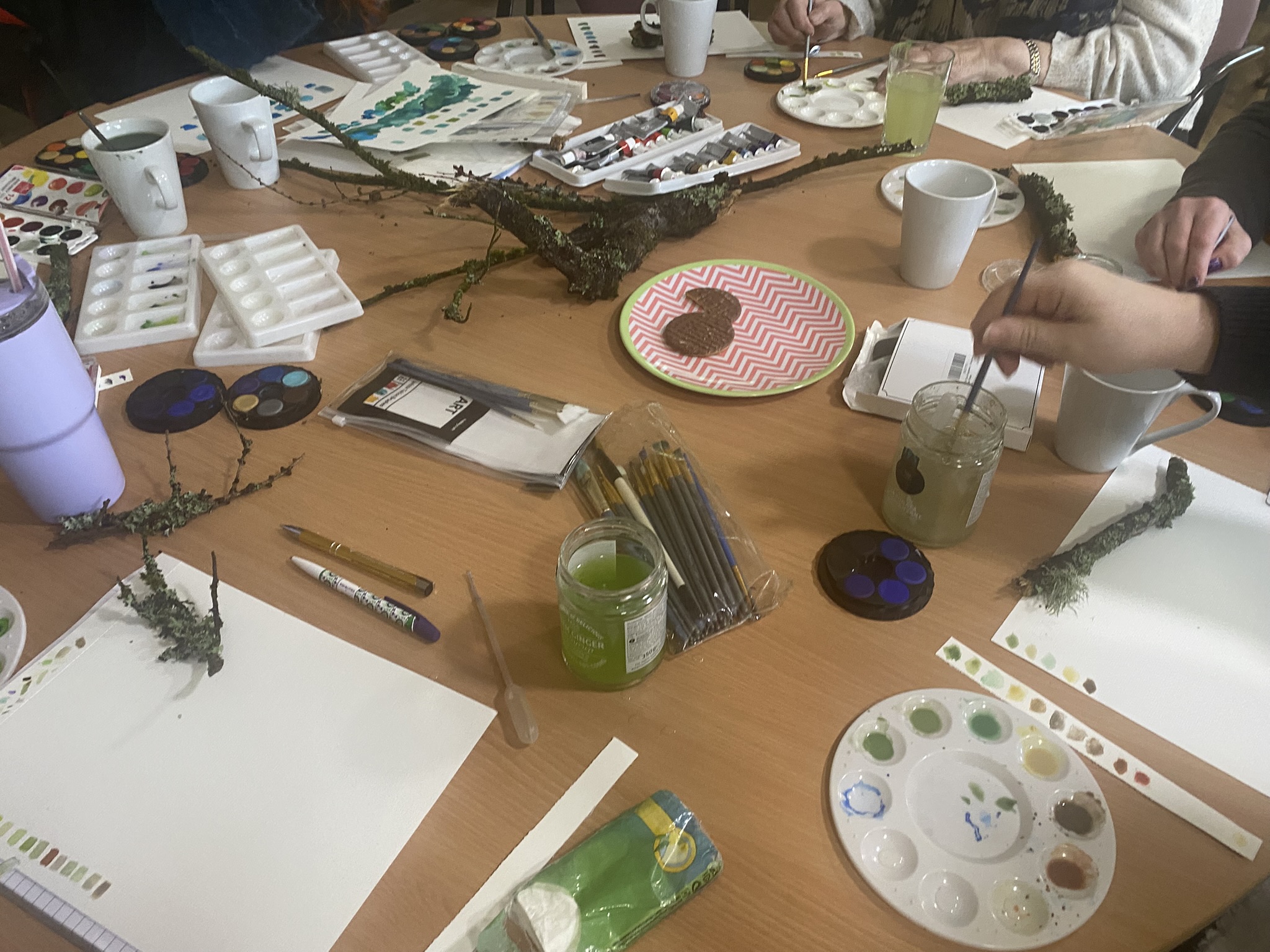 Participants painting with natural materials during Head Outdoors Mobility