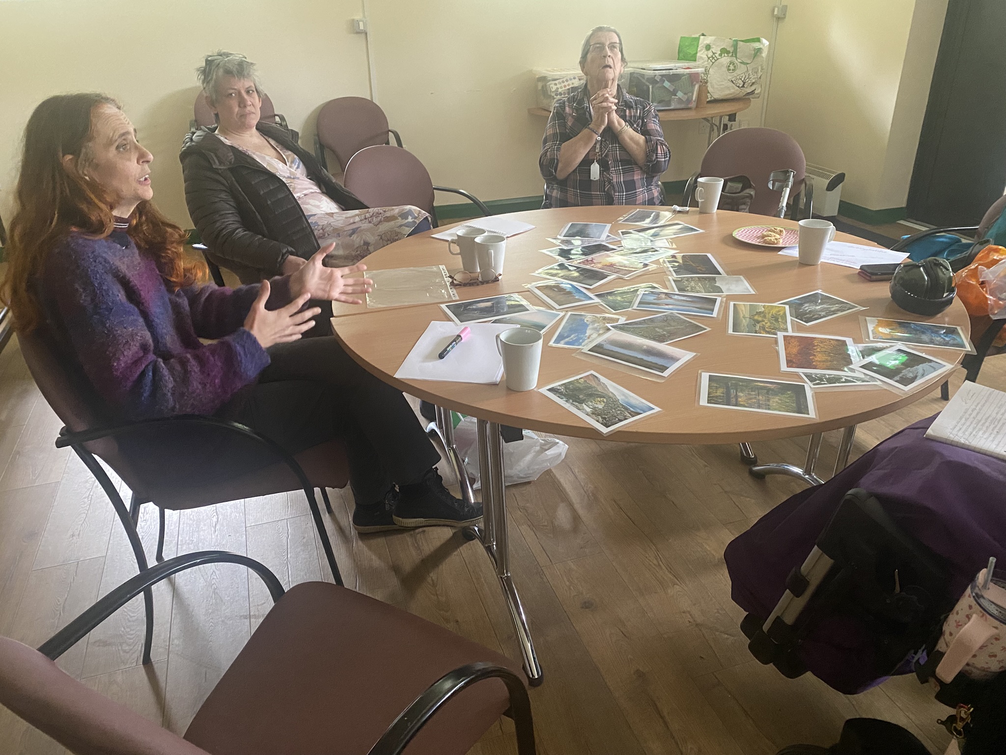 People sharing a supportive conversation together around a table