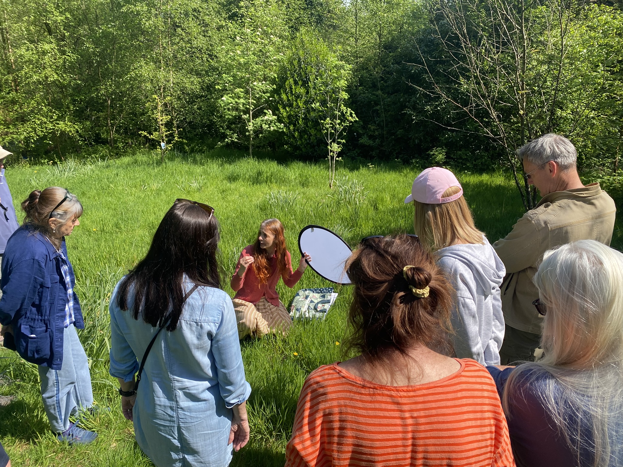 Community members taking part together in a sunny outdoor space