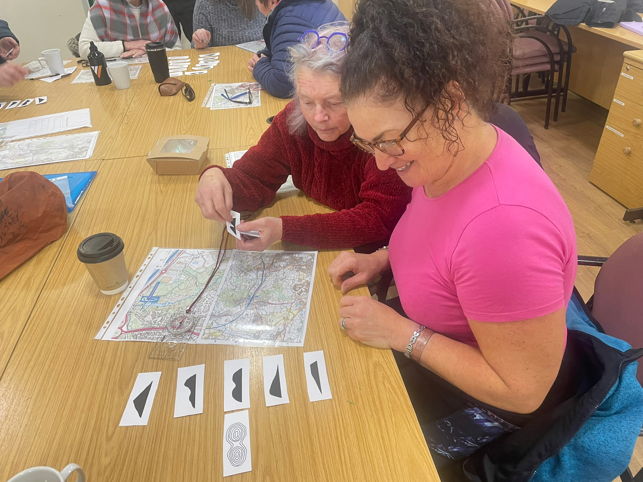 Head Outdoors participants learning practical navigation skills inside the woodland facility