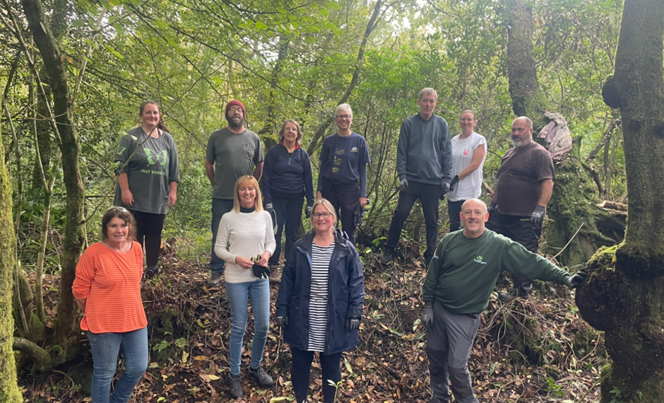 Nature Nurture conservation group standing together in the woodland