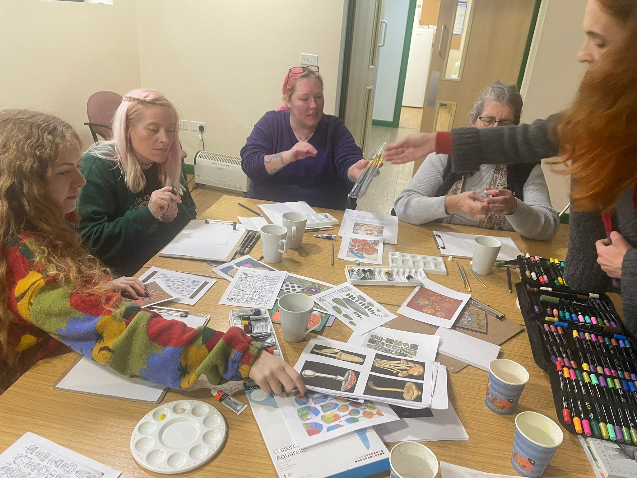 Head Outdoors participants taking part in a creative workshop inside the woodland facility